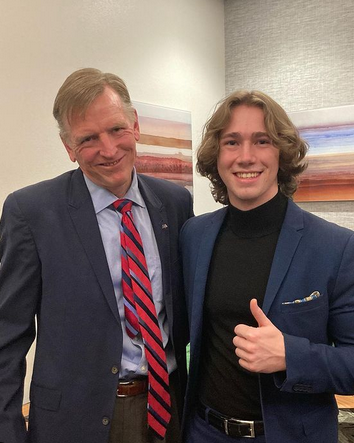 Kai Schwemmer and Paul Gosar smile for a photo, with Kai giving a thumbs up.